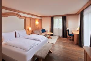 a hotel room with a bed and a living room at Engels Park in Vipiteno +73 photos