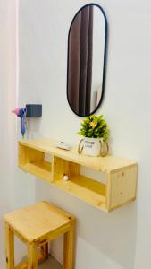 a wooden shelf on a wall with a mirror at The Heaven Luxe Pangandaran in Pangandaran