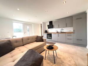 a living room with a couch and a table at An der Grüh in Großsolt +6 photos
