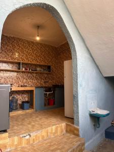 a room with a stone wall and an archway at The Blue House in Amman