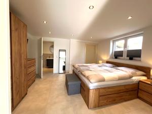 a bedroom with a large bed and a television at An der Grüh in Großsolt