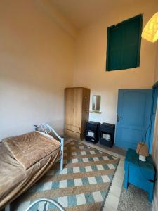 a bedroom with a bed and a table in a room at The Blue House in Amman
