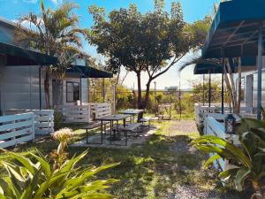 a patio with a table and benches and trees at Pet Truelove in Hengchun South Gate