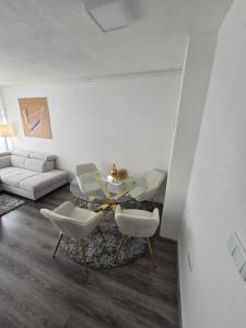 a living room with a couch and a table and chairs at Apartman Central Lux in Banja Luka