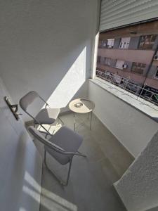 a balcony with a chair and a table and a window at Apartman Central Lux in Banja Luka +13 photos