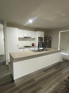 a kitchen with white cabinets and a counter top at Accomodation at Lavington in Lavington