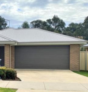 a house with a garage with at Accomodation at Lavington in Lavington