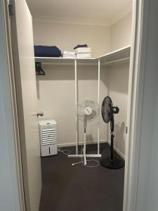 a room with a room with a fan and a shelf at Accomodation at Lavington in Lavington