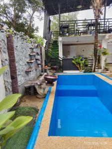 a pool in the backyard of a house at Pamarayeg Room in Bilar
