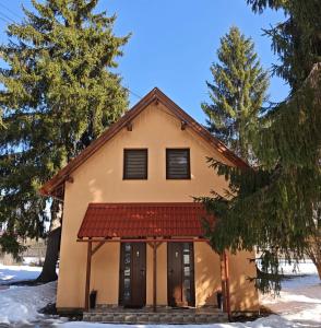 a house with a red roof in the snow at ADAM-OASIS in Borzont