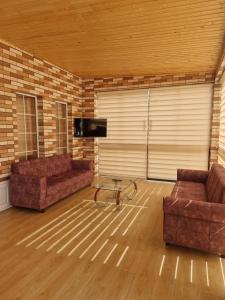 a living room with two couches and a tv at Brick Villas in Qusar