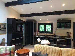 a living room with black and white furniture at La Becada de las Landas in Seignosse +17 photos
