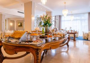 a buffet of food on a table in a room at Hotel Biancamano in Rimini