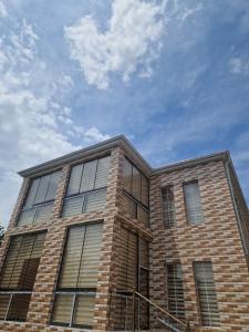 a brick building with a blue sky in the background at Brick Villas in Qusar