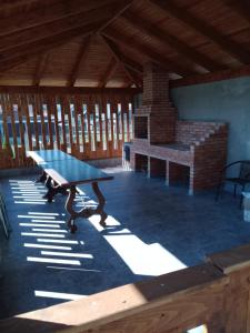 a ping pong table in a pavilion with a fireplace at Pensiunea Ovidiu in Beclean