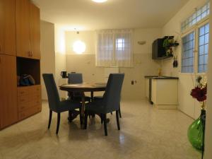 a kitchen and dining room with a table and chairs at Civico 55 in Casale Torre San Giovanni +16 photos