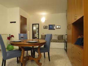 a dining room with a table and chairs and a couch at Civico 55 in Casale Torre San Giovanni