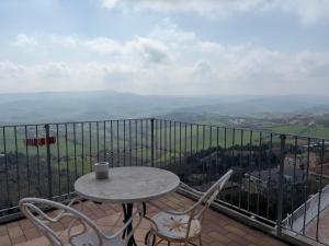 a table and chairs on a balcony with a view at B&B Falconi in Fermo