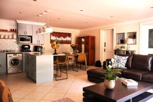 a kitchen and living room with a couch and a table at Vitry Country Estate in Gqeberha