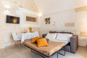 a living room with a couch and a table at Casa Roma 78 Traditional Stone House in Monopoli Center in Monopoli