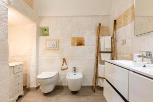 a bathroom with a toilet and a sink at Casa Roma 78 Traditional Stone House in Monopoli Center in Monopoli +15 photos