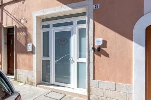 a door to a building with a sign on it at Casa Roma 78 Traditional Stone House in Monopoli Center in Monopoli