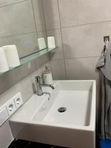a white sink in a bathroom with a mirror at Haus Natalie in Bartholomäberg