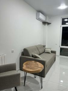 a living room with a couch and a coffee table at Touch the Coast in Batumi