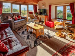 a living room with a couch and a table at Shelterstone in Elgin