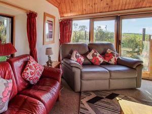 a living room with a couch and a chair at Shelterstone in Elgin