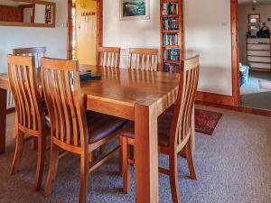 a wooden dining room table with four chairs around it at Shelterstone in Elgin