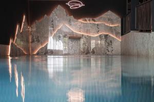 a room with a pool of water in a building at Almhotel Glieshof in Malles Venosta