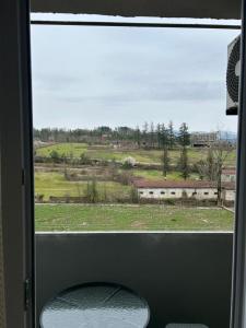 a window of a train with a view of a field at Hotel Tamo in Tsqaltubo