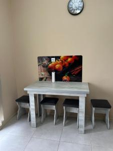 a table with chairs and a picture of fruit at Hotel Tamo in Tsqaltubo