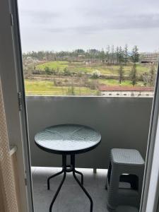 a table and a stool in front of a window at Hotel Tamo in Tsqaltubo +10 photos