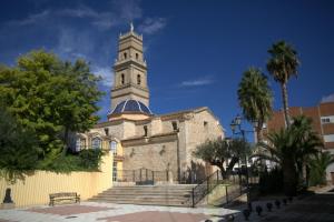 a building with a clock tower on top of it at Casa El Chasquín in Caudete de las Fuentes