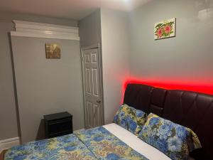 a bedroom with a bed with a red light at Grove#8 in Irvington +14 photos