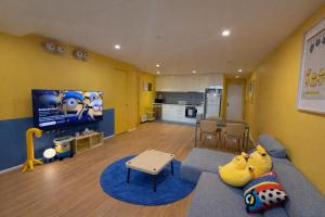 a living room with a blue couch and a kitchen at Banana Bliss - Spacious 2 Bedroom CBD Apartment with 2 Balconies, 2 Bathrooms & Parking Option in Melbourne