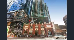 a building in the middle of a city with tall buildings at Banana Bliss - Spacious 2 Bedroom CBD Apartment with 2 Balconies, 2 Bathrooms & Parking Option in Melbourne