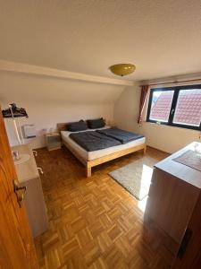 a bedroom with a bed in the middle of a room at Ferienwohnung Marie in Kurort Steinbach-Hallenberg