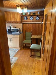 a small kitchen with a table and a microwave at Ferienwohnung Marie in Kurort Steinbach-Hallenberg