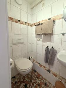 a bathroom with a toilet and a sink at Gästehaus Stefan Koch in Rust
