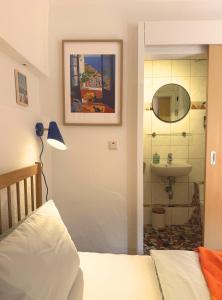 a bedroom with a bed and a sink and a mirror at Gästehaus Stefan Koch in Rust +3 photos