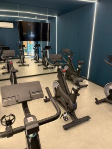 a gym with rows of exercise equipment in a room at Luxo e Conforto 2Q Bueno- Proximo Vaca Brava 2103 in Goiânia +34 photos