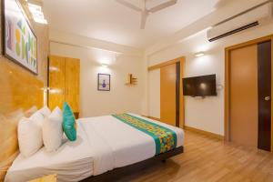a hotel room with a bed and a tv at Treebo Ace Luxe in New Delhi +44 photos