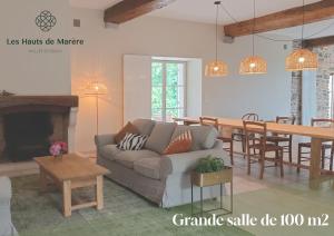 a living room with a couch and a dining room at Maison d'exception, 14 personnes, piscine, vue Pyrénées in Sévignacq-Meyracq