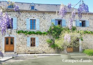 a stone house with purple flowers in front of it at Maison d'exception, 14 personnes, piscine, vue Pyrénées in Sévignacq-Meyracq +22 photos