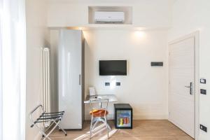 a room with a desk and a tv on a wall at Hotel Aphrodite in Rome