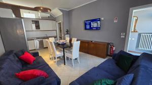 a living room with a blue couch and a table at Terry House in Sirmione