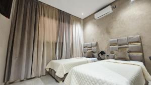 a bedroom with two beds and a window at Modern Design Villa Private Pool Marrakech in Marrakesh +30 photos